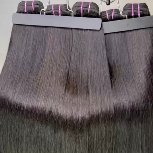 Hair extensions displayed on a stand with clips holding them in place.