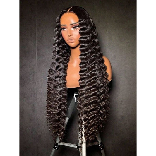Mannequin head with long, wavy black hair on a dark backgroundBurmese curly wig displayed on mannequin”